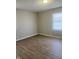 Spacious bedroom with wood-look flooring and neutral walls at 9710 E 38Th St, Indianapolis, IN 46235