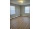 Large bedroom featuring neutral walls and wood-look flooring at 9710 E 38Th St, Indianapolis, IN 46235