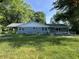 Charming single-story home with a blue-painted brick exterior and a convenient wheelchair ramp at 9710 E 38Th St, Indianapolis, IN 46235