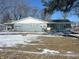 Ranch home with gray siding, snow-covered yard, and accessible ramp at 9710 E 38Th St, Indianapolis, IN 46235