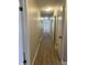 Long hallway with light walls and wood-look flooring at 9710 E 38Th St, Indianapolis, IN 46235