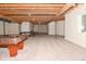 Finished basement with pool table, ping pong table, and exposed beams at 10100 Sanctuary Dr, Brownsburg, IN 46112