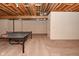 Unfinished basement with ping pong table and exposed beams at 10100 Sanctuary Dr, Brownsburg, IN 46112