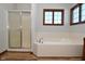 Bathroom boasts a shower, soaking tub, and updated flooring at 10100 Sanctuary Dr, Brownsburg, IN 46112