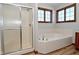 Bathroom with shower, tub, and updated flooring at 10100 Sanctuary Dr, Brownsburg, IN 46112