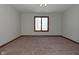 Bright bedroom featuring a large window with water views and neutral carpeting at 10100 Sanctuary Dr, Brownsburg, IN 46112