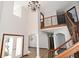 Two-story foyer with hardwood floors, chandelier, and double doors at 10100 Sanctuary Dr, Brownsburg, IN 46112