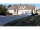 Brick home with a three-car garage and manicured landscaping at 10100 Sanctuary Dr, Brownsburg, IN 46112