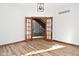 Elegant hallway with hardwood floors and double doors leading upstairs at 10100 Sanctuary Dr, Brownsburg, IN 46112