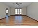 Living room with hardwood floors, large window, and ceiling fan at 10100 Sanctuary Dr, Brownsburg, IN 46112