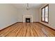 Spacious living room featuring hardwood floors, a fireplace, and large windows at 10100 Sanctuary Dr, Brownsburg, IN 46112