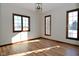 Sunlit office space with hardwood floors and large windows at 10100 Sanctuary Dr, Brownsburg, IN 46112