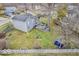 Aerial view of the house with a backyard deck, mature trees, green lawn, and shed at 11237 Baycreek Dr, Indianapolis, IN 46236