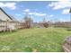 Spacious backyard featuring a swing bench, green grass, and a wood fence at 11237 Baycreek Dr, Indianapolis, IN 46236