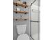 Bright bathroom showcasing a glass-enclosed shower, neutral walls, and floating shelves at 11237 Baycreek Dr, Indianapolis, IN 46236