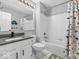 Bright bathroom featuring a shower-tub combo and neutral dinosaur-themed shower curtain at 11237 Baycreek Dr, Indianapolis, IN 46236