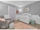 Cozy Bedroom with soft colors, a crib, and a comfortable rocking chair on a plush rug at 11237 Baycreek Dr, Indianapolis, IN 46236