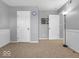 Spacious bonus room offering carpeting, wainscoting, and versatile space for recreation or relaxation at 11237 Baycreek Dr, Indianapolis, IN 46236