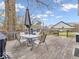 Relaxing outdoor deck featuring a table, chairs, and outdoor cooking area at 11237 Baycreek Dr, Indianapolis, IN 46236
