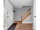 Bright foyer with wood flooring, staircase, and a glimpse into other living spaces at 11237 Baycreek Dr, Indianapolis, IN 46236