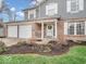 Close-up view of home's exterior showcasing a well-maintained lawn and charming front porch at 11237 Baycreek Dr, Indianapolis, IN 46236