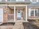Welcoming front entrance featuring a charming porch, brick accents, and decorative wreath at 11237 Baycreek Dr, Indianapolis, IN 46236