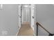 Neutral-toned hallway with carpet flooring, featuring a growth chart and access to multiple rooms at 11237 Baycreek Dr, Indianapolis, IN 46236