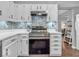 Spacious kitchen featuring stainless steel oven and bright white cabinets at 11237 Baycreek Dr, Indianapolis, IN 46236