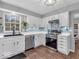 Well-lit kitchen with white cabinetry, stainless steel oven, and modern backsplash at 11237 Baycreek Dr, Indianapolis, IN 46236
