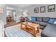 Comfortable living area with a sectional sofa, decorative rug, and an open floor plan at 11237 Baycreek Dr, Indianapolis, IN 46236