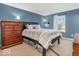 Comfortable main bedroom with blue walls, a plush bed, and ample storage space at 11237 Baycreek Dr, Indianapolis, IN 46236