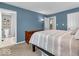 Bright and airy main bedroom featuring a neutral palette, a dresser, and a view into the en-suite bathroom at 11237 Baycreek Dr, Indianapolis, IN 46236