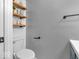 Stylishly designed powder room featuring floating shelves, modern fixtures, and a clean, minimalist aesthetic at 11237 Baycreek Dr, Indianapolis, IN 46236