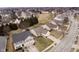 Aerial view of a neighborhood showcasing homes with mature trees and landscaping in a residential area at 12243 Carriage Stone Dr, Fishers, IN 46037