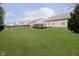 Green backyard with a black metal fence and a wooden deck great for entertaining guests at 12243 Carriage Stone Dr, Fishers, IN 46037