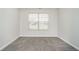 Bedroom featuring neutral walls, carpeted floors, and natural light from the window at 12243 Carriage Stone Dr, Fishers, IN 46037