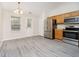Modern kitchen with stainless steel appliances, sleek gray floors, and a dining area perfect for everyday meals at 12243 Carriage Stone Dr, Fishers, IN 46037
