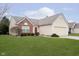 A beautiful home with a lush green lawn, and a well-maintained exterior. Includes a two-car garage and inviting curb appeal at 12243 Carriage Stone Dr, Fishers, IN 46037