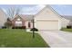 Charming single-Gathering home featuring a well-manicured lawn, a two-car garage, and a welcoming front entrance at 12243 Carriage Stone Dr, Fishers, IN 46037