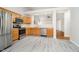 Eat-in kitchen featuring modern stainless steel appliances, ample counter space, and stylish gray flooring at 12243 Carriage Stone Dr, Fishers, IN 46037