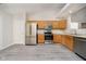 Contemporary kitchen with stainless steel appliances, gray flooring, ample counter space, and lots of natural light at 12243 Carriage Stone Dr, Fishers, IN 46037