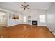 Spacious living room with a cozy fireplace, high ceilings, and sleek hardwood floors leading into the open-concept kitchen at 12243 Carriage Stone Dr, Fishers, IN 46037