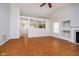 Bright living room with fireplace, hardwood floors, and an open view to the kitchen and dining area for easy interaction at 12243 Carriage Stone Dr, Fishers, IN 46037