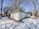 Detached garage with double doors and snowy surroundings at 1307 W Congress Ave, Indianapolis, IN 46208