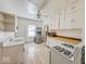 Galley kitchen with white cabinets and built in microwave at 1307 W Congress Ave, Indianapolis, IN 46208