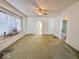 Large living room with green carpet and arched doorways at 1307 W Congress Ave, Indianapolis, IN 46208