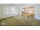 Large living room with green carpet and arched doorways at 1307 W Congress Ave, Indianapolis, IN 46208