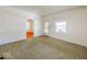 Large living room with green carpet and arched doorways at 1307 W Congress Ave, Indianapolis, IN 46208
