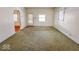 Large living room with green carpet and arched doorways at 1307 W Congress Ave, Indianapolis, IN 46208