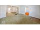 Large living room with green carpet and arched doorways at 1307 W Congress Ave, Indianapolis, IN 46208